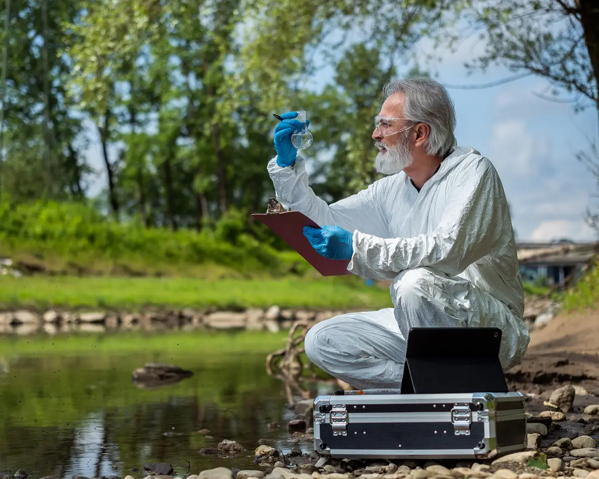 Ecologist conducting field analysis by river